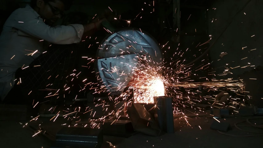 welders using a grinder on metal