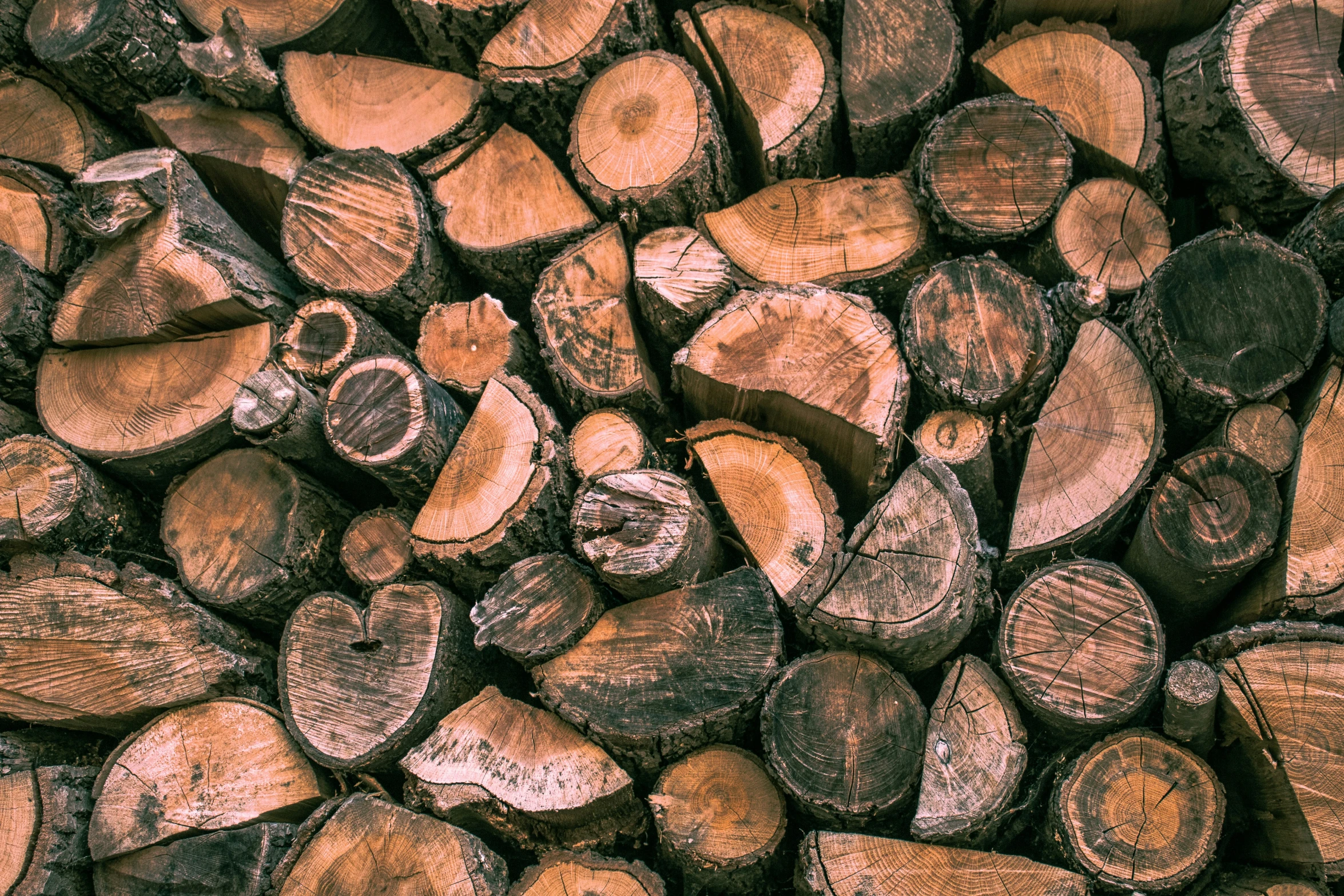 some wooden logs are piled on top of each other