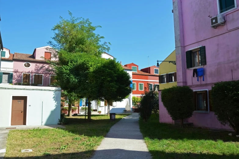 a street view shows a sidewalk with several buildings lining both sides of it