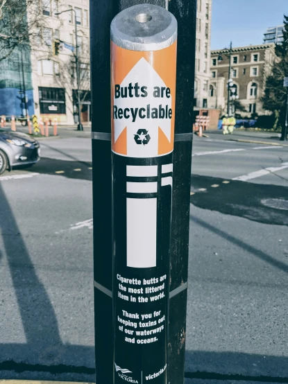 a pole with a sticker on it that is giving the message s are recyclable