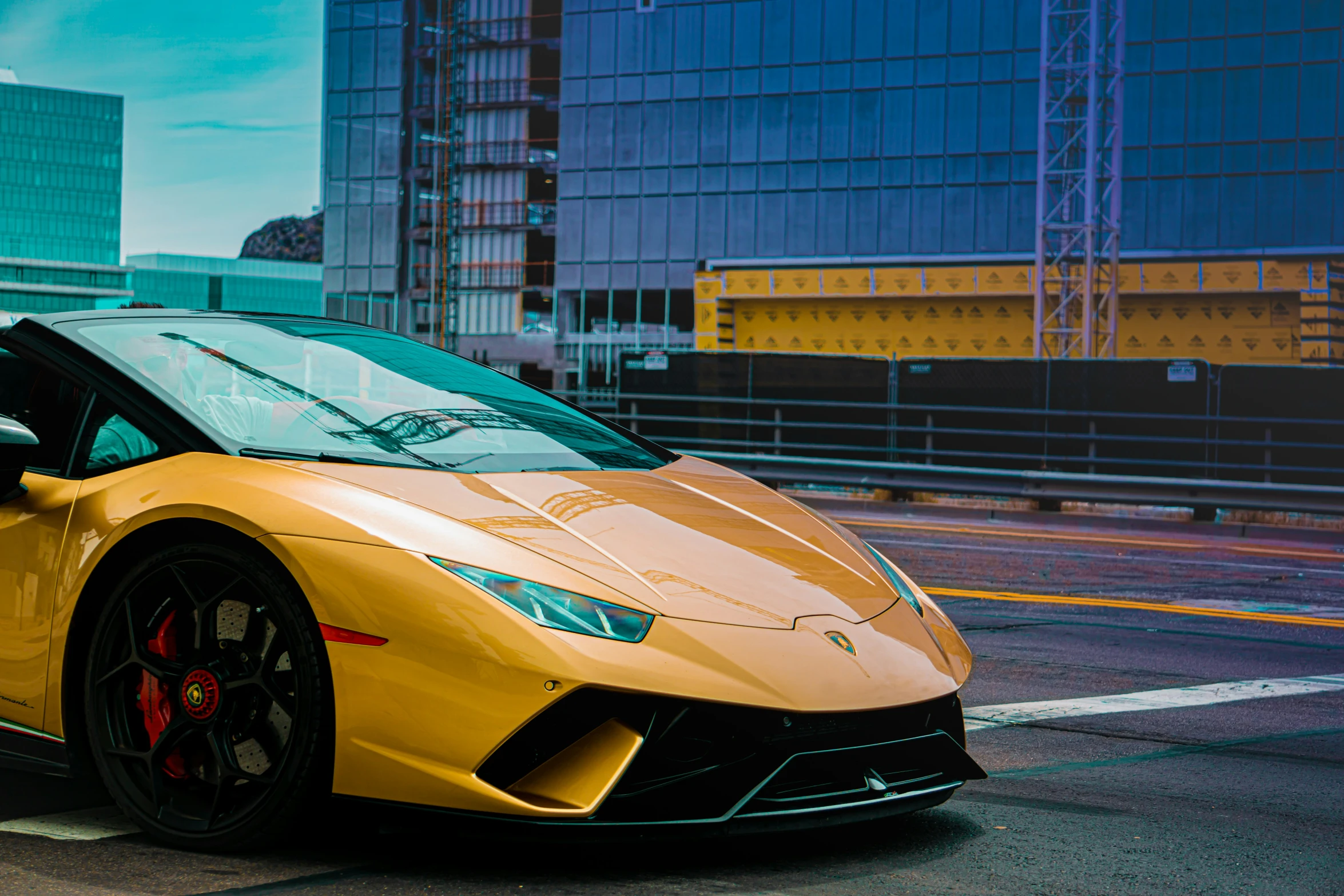 the large yellow lambroam is parked in front of the building