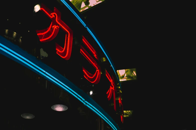 a neon sign that is on top of the building