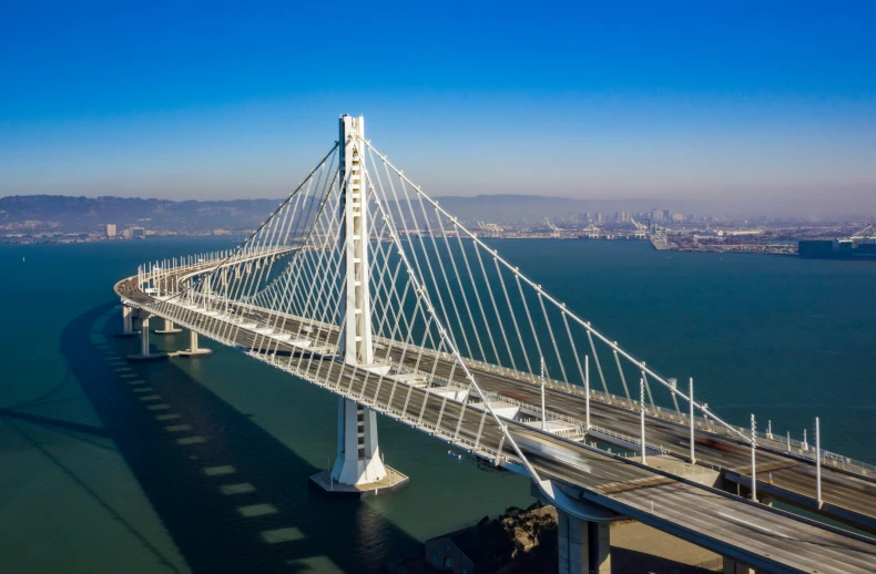 a very long bridge over water with traffic