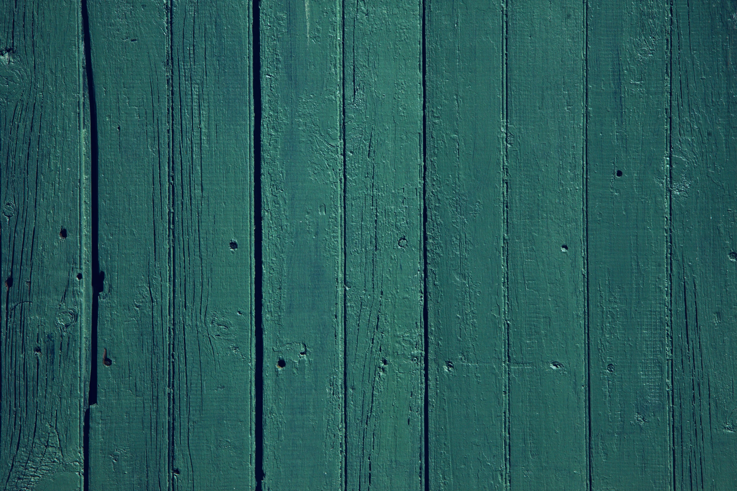 a dark green wood surface with planks or boards