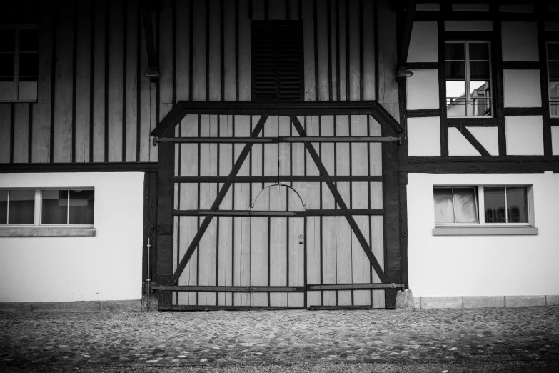 a black and white po of a big door with bars