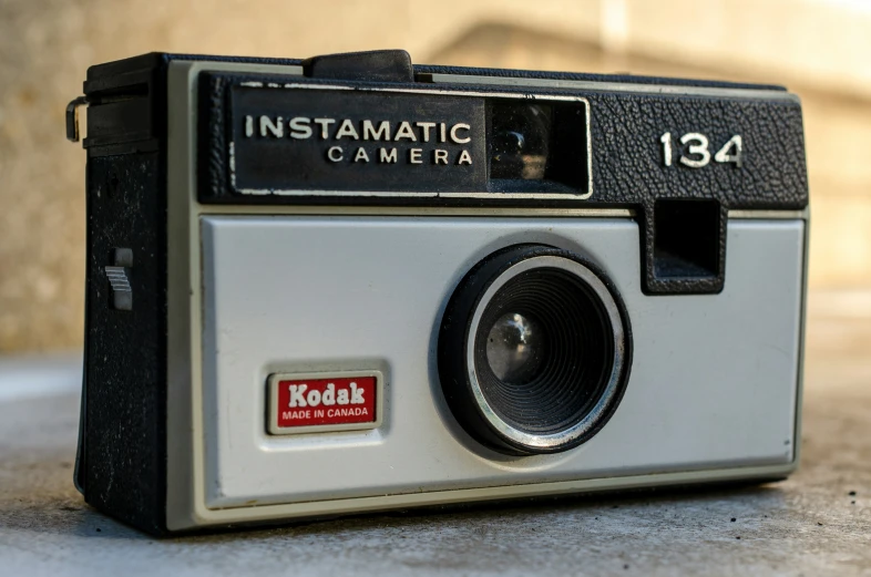 a kodak instant instant camera is laying on the ground