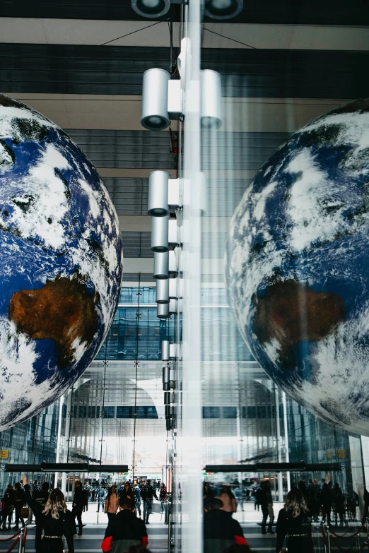 two large globes hanging from the ceiling of a building