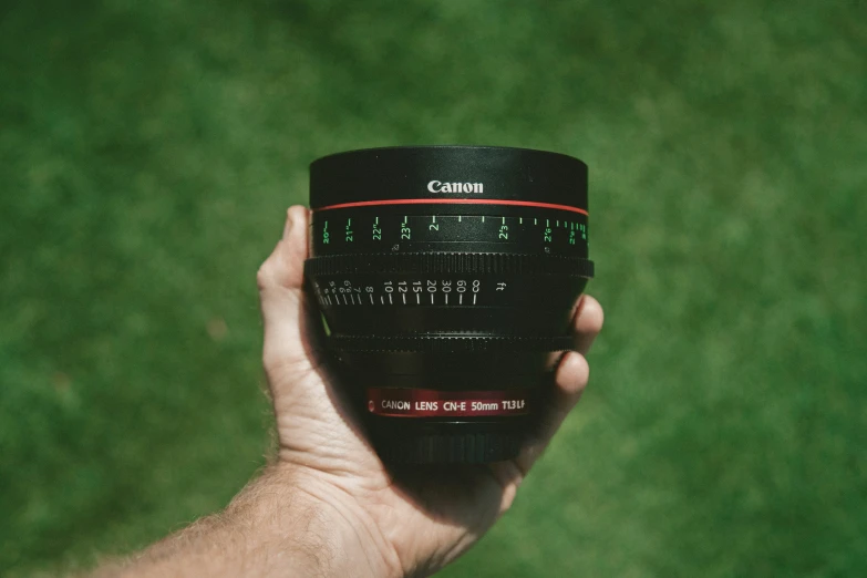 a hand holding a coffee mug with the words film on it