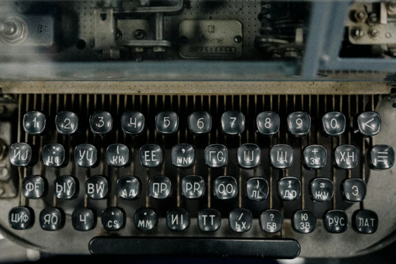 an old typewriter with metal numbers and some writing