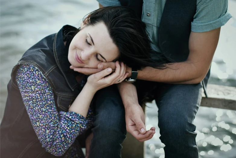 a man and a woman with hands on their face