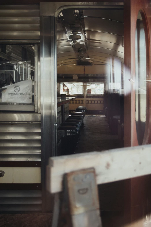 an open door in a train car with a sign