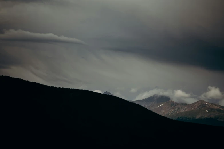 a view from the back of the mountains looking at clouds