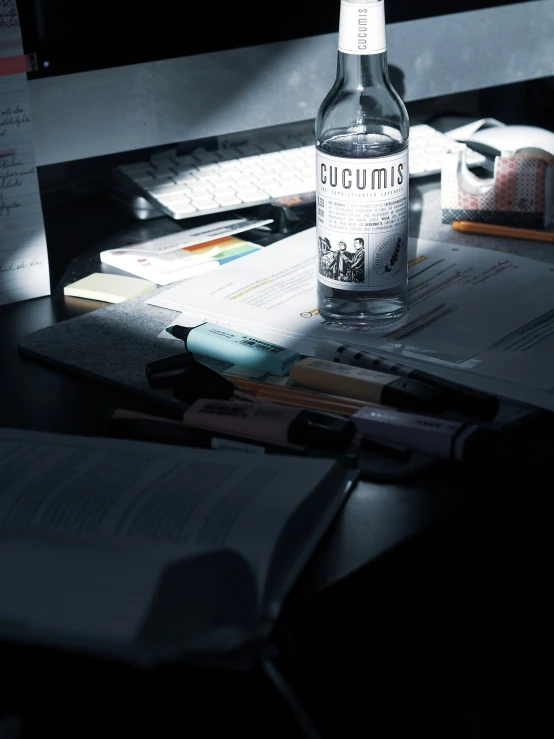 an empty bottle of tonic on a desk