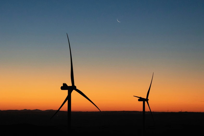 a group of wind turbines towering in the sky