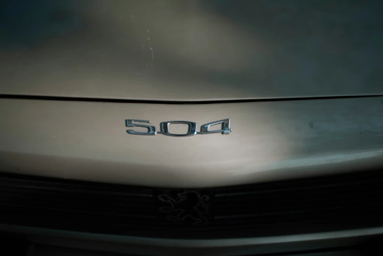 front end emblem on the hood of a silver car