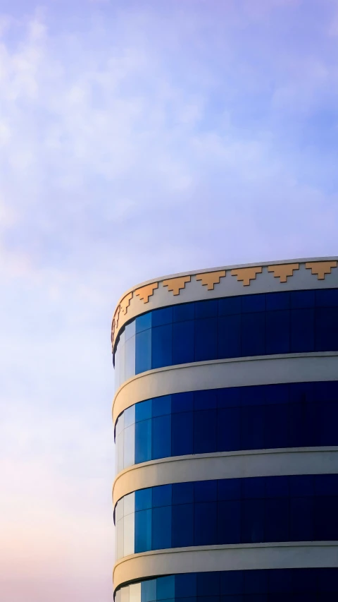 the plane is flying above the building in the blue sky