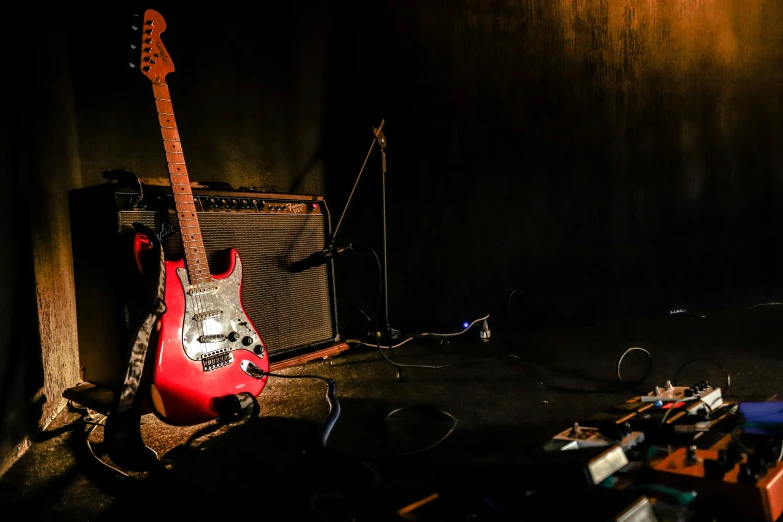 a guitar is shown in a dark room