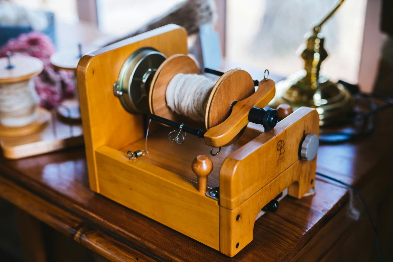 a wooden spool of thread being sewn on