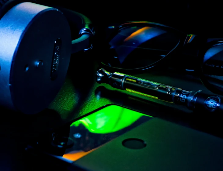 a black background with neon green light and headphones