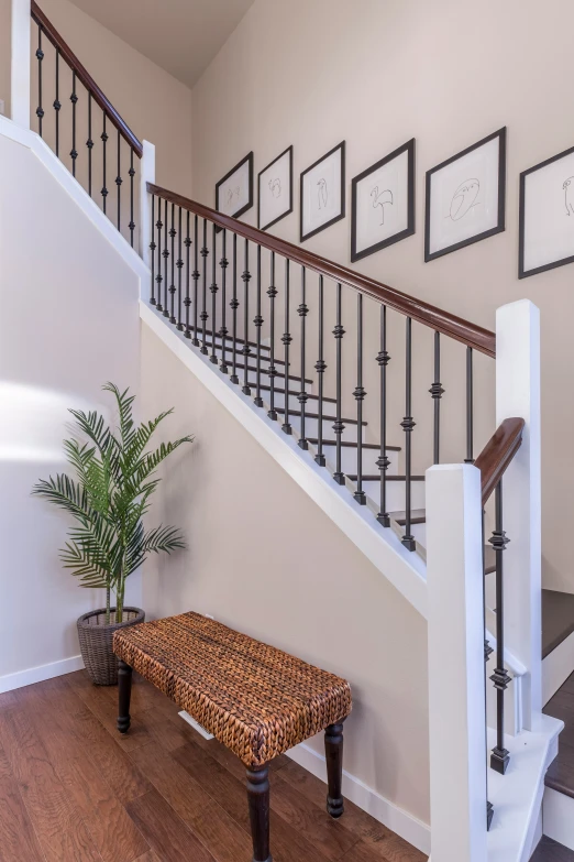 a set of stair railings near a bench in front of a staircase