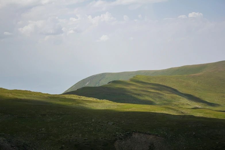 a very large hill with a long cross country road