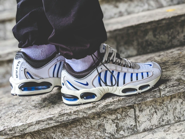 a white, blue, and black nike shoe with white lettering