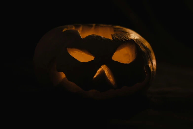 a jack o lantern with eyes glowing on it