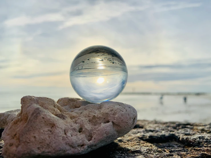 an image of a glass ball on top of rocks