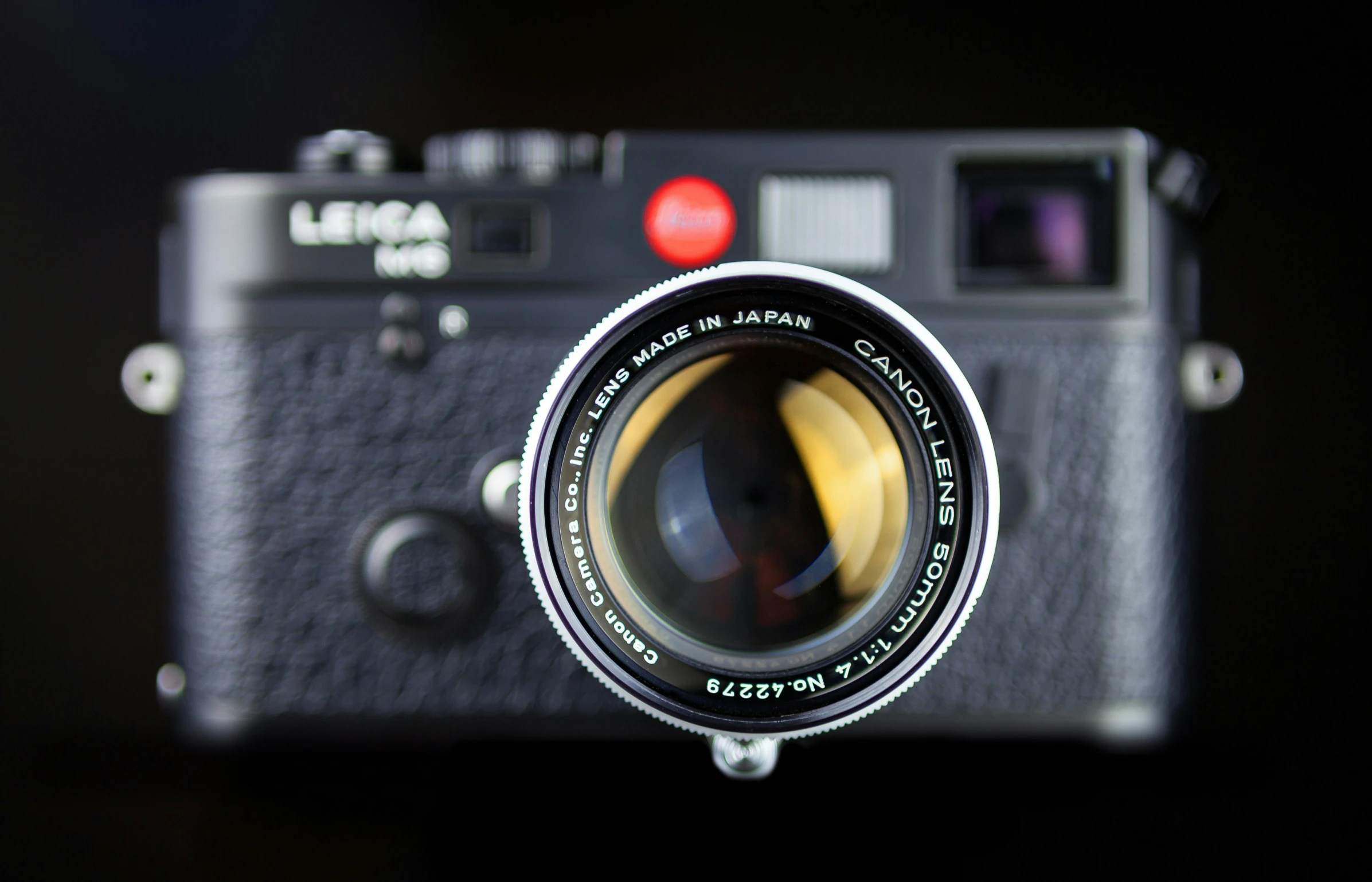 the top of an old black camera on a black background