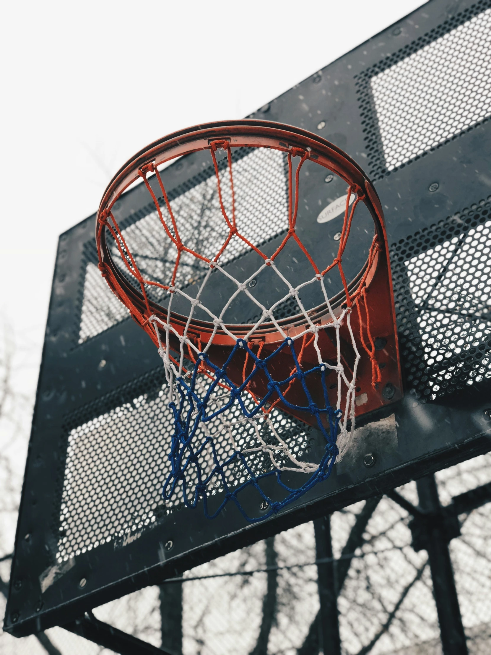 a basketball hoop with the net broken and in the air