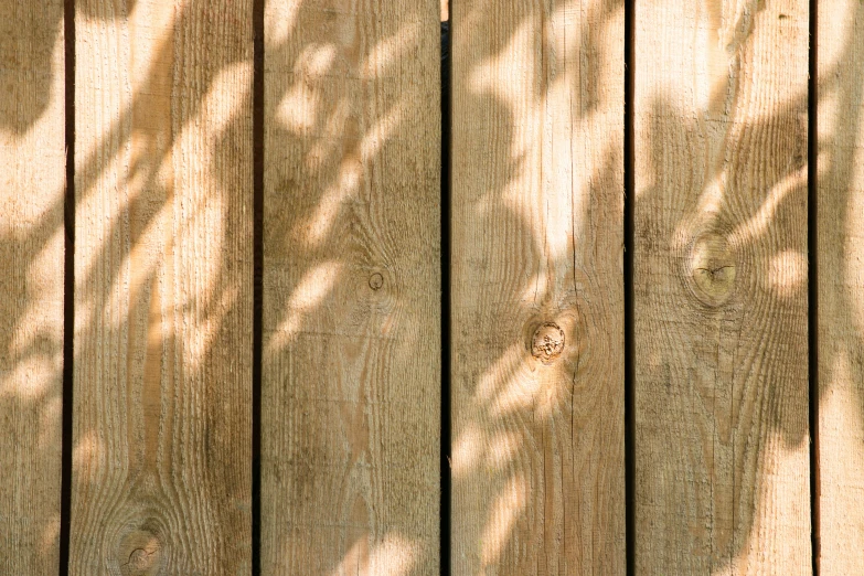 a fence with a wood surface and a stop sign