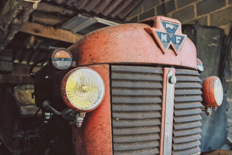 a closeup of an old truck parked next to a building