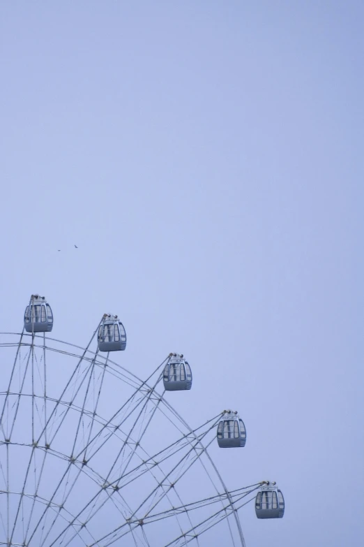 a ferris wheel and a blue sky as seen from the ground