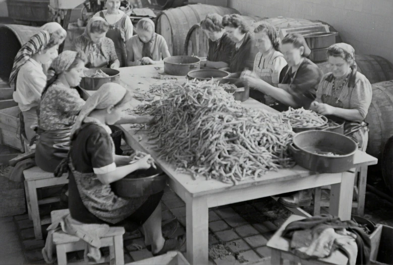 a bunch of girls sitting around a table in an old po