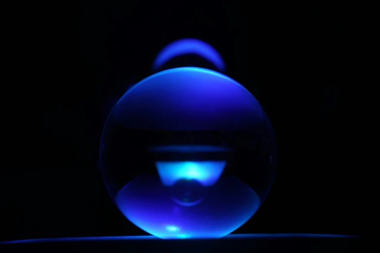 a blue and black po of a sphere in the dark