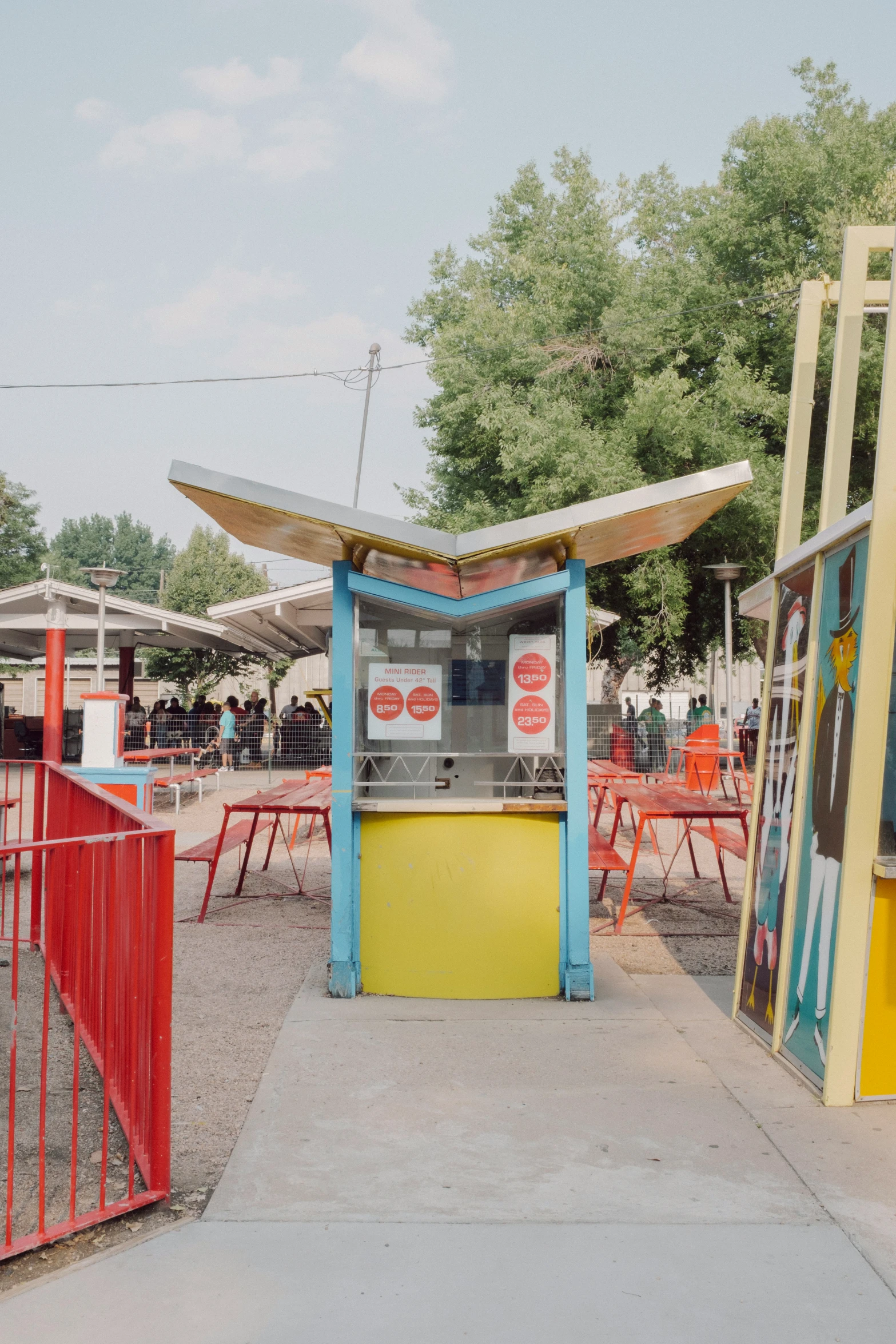 an old fashioned vending machine outside a red fence