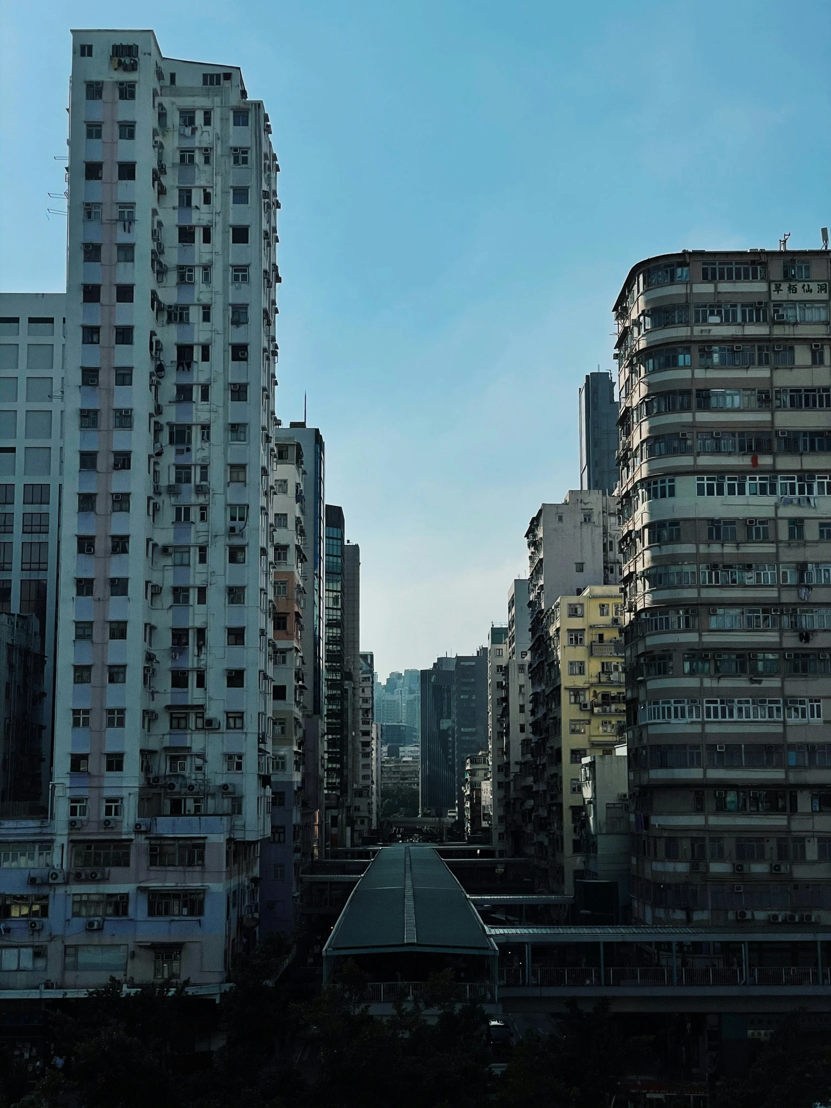 a line of high rise buildings in a city with clear blue skies