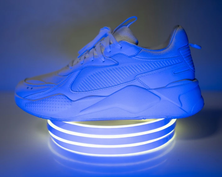 a shoe is glowing against a blue background