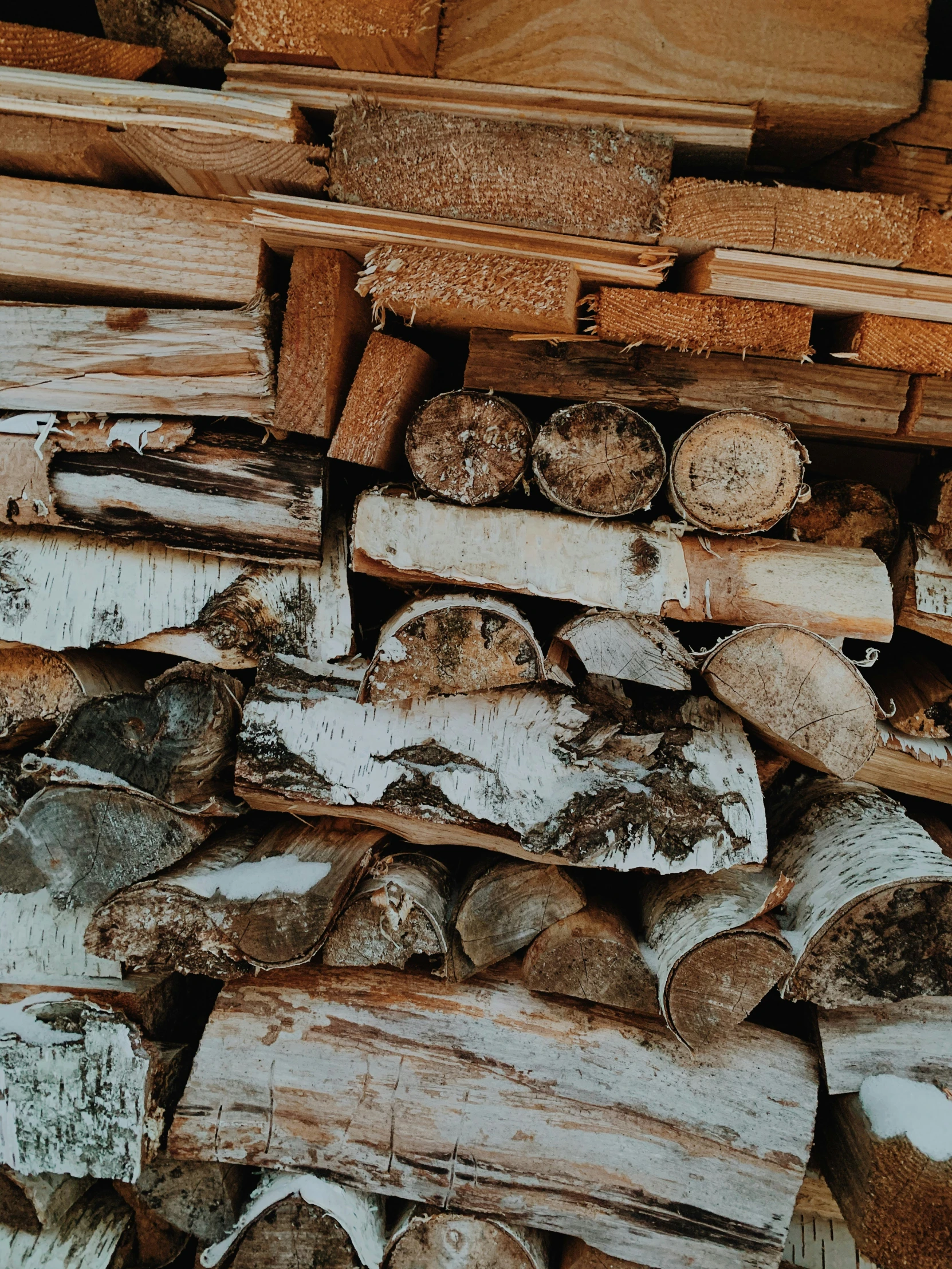 a pile of wooden logs and crates stacked on top of each other