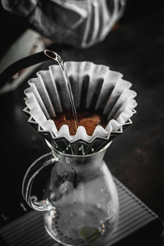 an artistic view of an espresso drip cup and pitcher