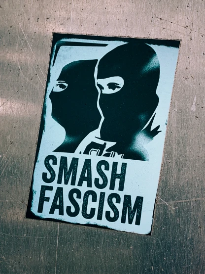 sticker that reads smash fascism is shown above a po of a person