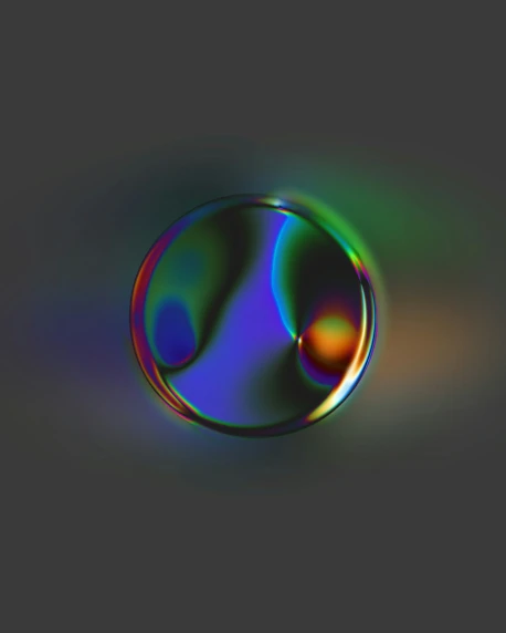 a drop of colorful liquid is on a grey background