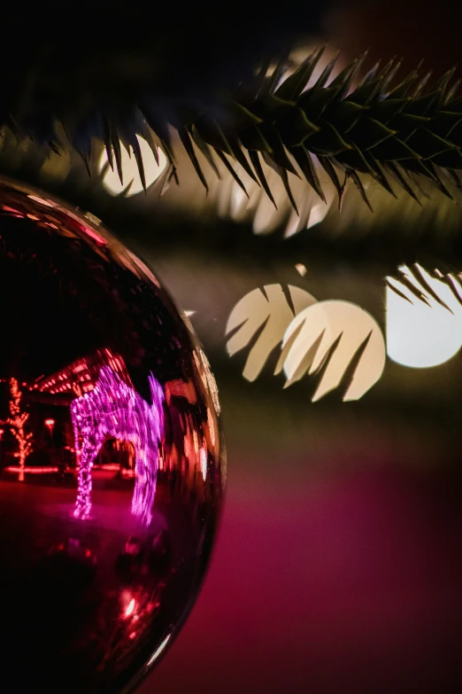 a shiny glass ornament hanging in a dark room