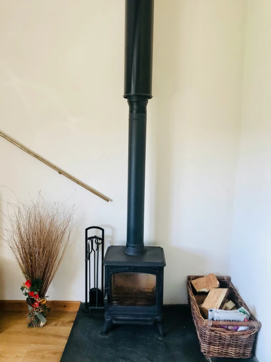 a wooden stove sitting next to an open basket