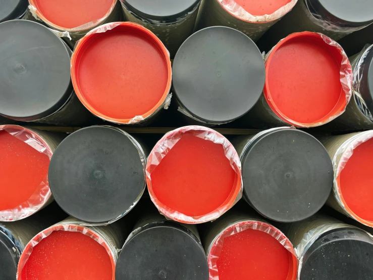 stacks of different color paint in metal barrels