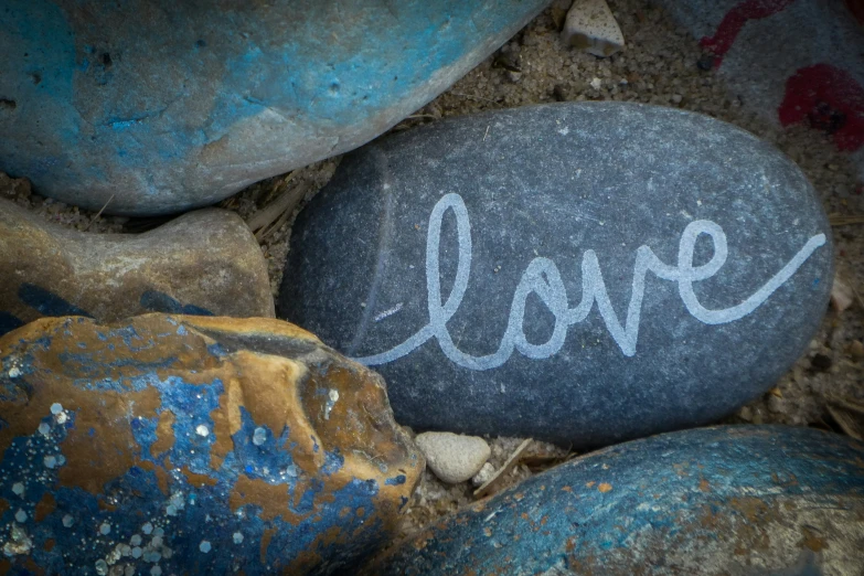 a close up of a rock with the word love written on it