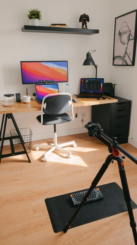 computer and video camera equipment on wooden floors in home office