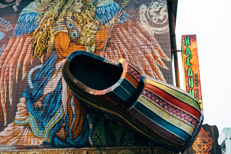 a pair of colorful loafers sits on the corner of a building