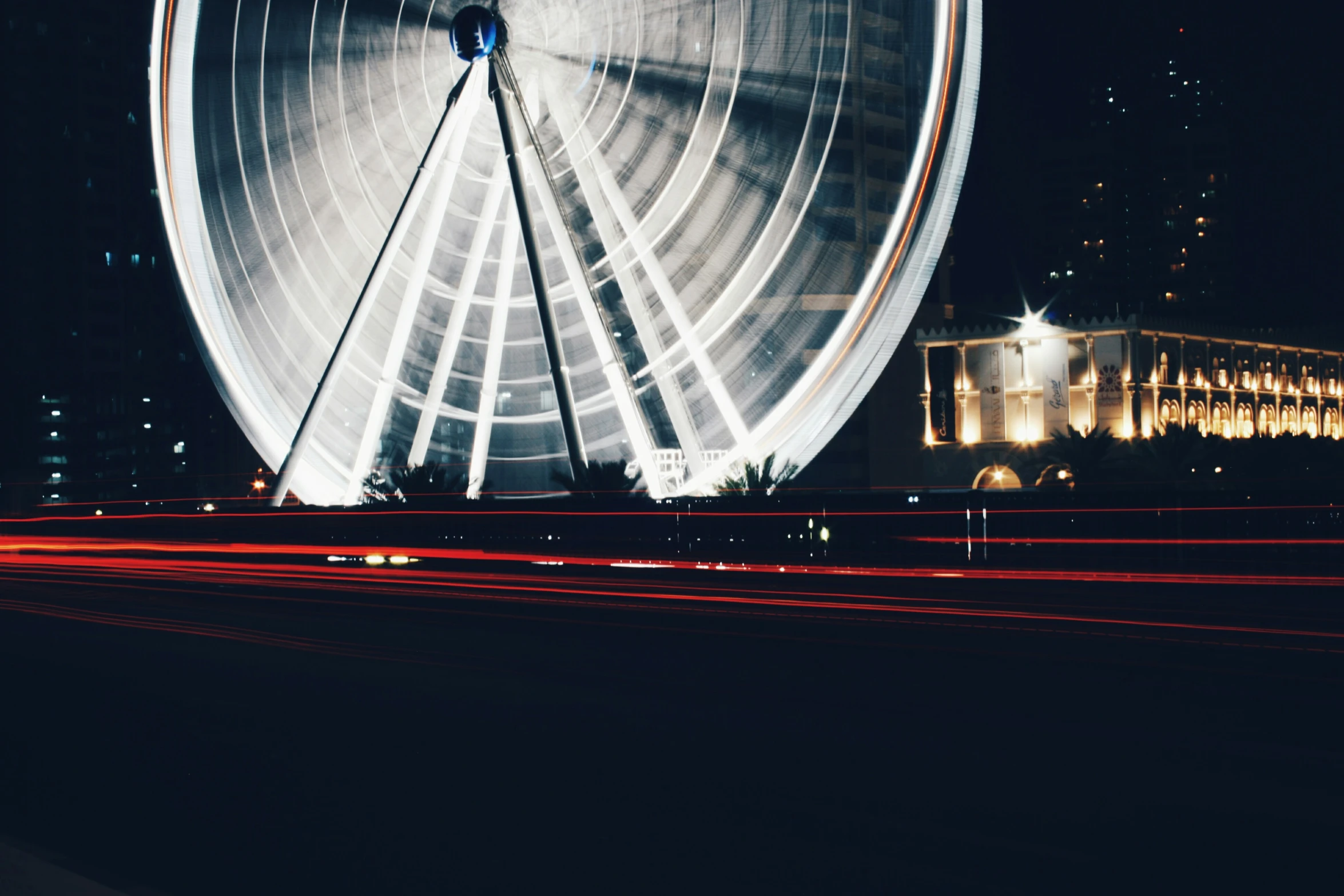 the ferris wheel lit up and shining in the night sky