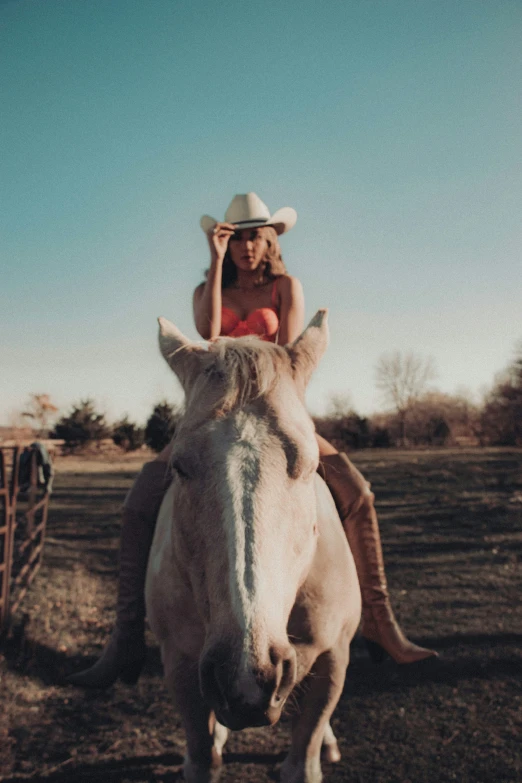 a person riding a horse wearing a hat